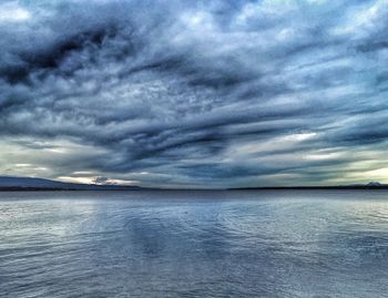 Scenic view of sea against cloudy sky