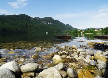 Rocks in lake against sky