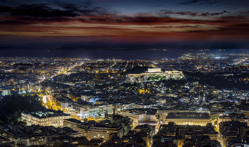 High angle view of illuminated cityscape against sky at night