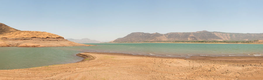 View of beach against mountain range