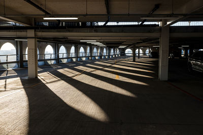 Uk, england, manchester, arches casting shadows in empty multi storey parking lot