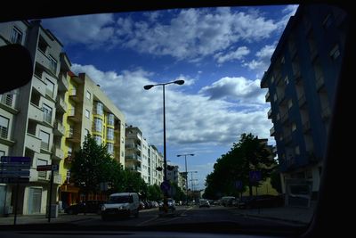 Low angle view of street in city against sky