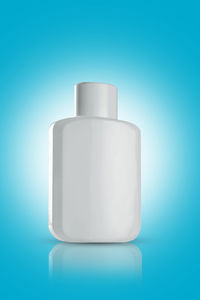 Close-up of white bottle against blue background