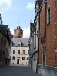 Street amidst buildings in town against sky