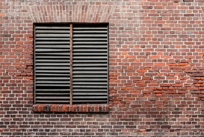 Closed window on brick wall