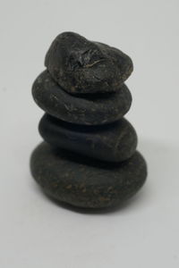 Close-up of stone stack against white background