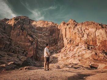 Rear view of man standing on rock