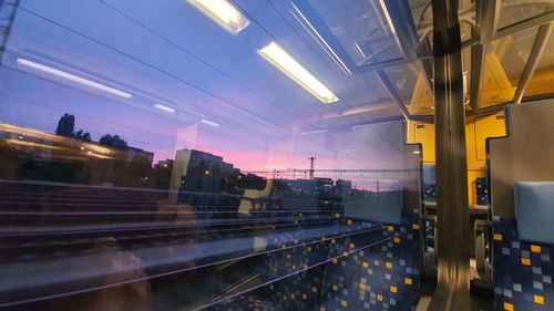 Blurred motion of tracks seen through moving train window during sunset