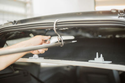 Close-up of man repairing car 