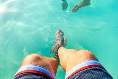 Low section of man in swimming pool