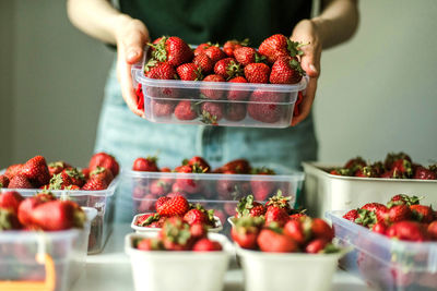 Close-up of woman holding strawberries