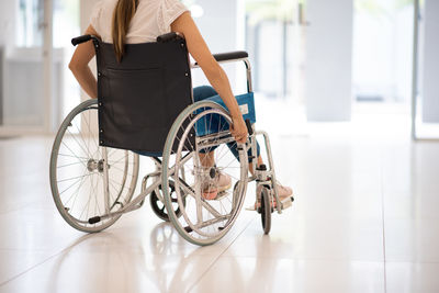 Low section of man with bicycle on floor