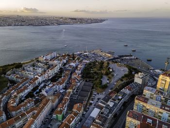 High angle view of buildings by sea against sky