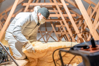 Side view of man working at construction site