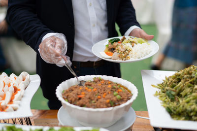 Midsection of man preparing food