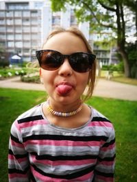 Portrait of boy wearing sunglasses standing outdoors