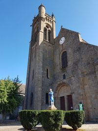 Low angle view of historic building against clear blue sky