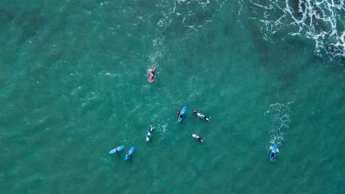 Group of surfers waiting to surf a wave