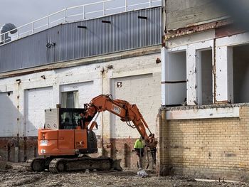 Man working at construction site against building