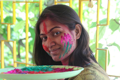 Close-up portrait of young woman having food at home