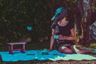 Woman holding cup outdoors