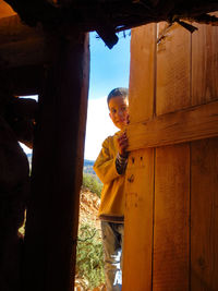 Portrait of boy looking through doorway