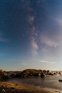 Scenic view of rocks against sky at night