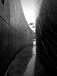 Footpath amidst buildings against sky