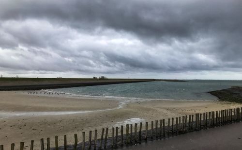 Scenic view of sea against cloudy sky