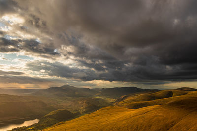 Scenic view of mountain against dramatic sky