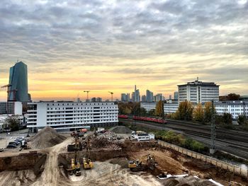 View of cityscape against cloudy sky