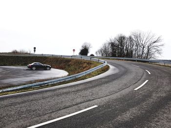 Car on road against clear sky