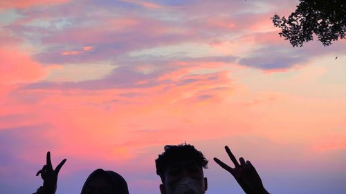 Silhouette people enjoying in sky during sunset