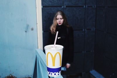 Close-up of young woman with drink