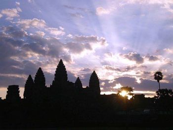 Silhouette of temple against sky during sunset