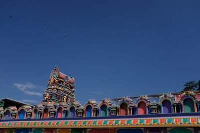 Low angle view of traditional building against blue sky