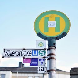 Low angle view of road sign against clear sky