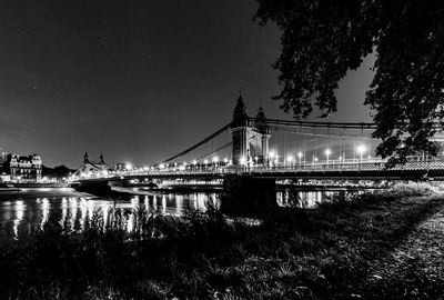 Bridge over river at night in black and white