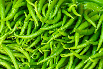 Full frame shot of green chili peppers for sale in market