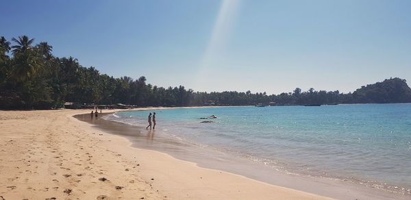 Scenic view of beach against clear sky