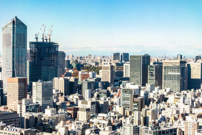 Aerial view of modern buildings in city against sky