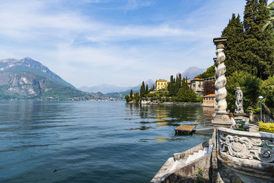 Scenic view of lake against mountains and cloudy sky