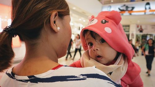 Close-up of mother and daughter in shopping mall