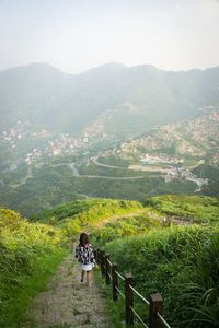 High angle view of woman on mountain range against sky