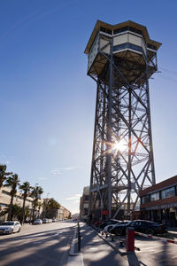 View of street tower against sky in city