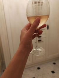 Close-up of hand holding wine glass