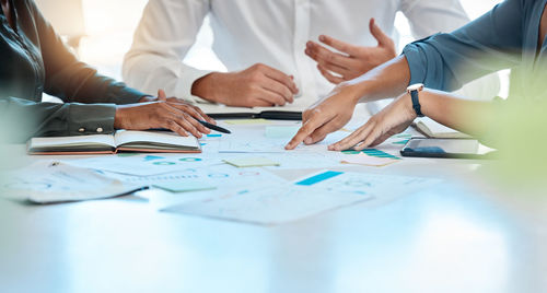 Midsection of business colleagues working at office