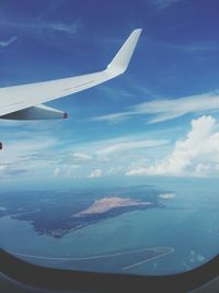 Cropped image of airplane flying over sea