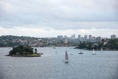 Panoramic view of sea and buildings against sky