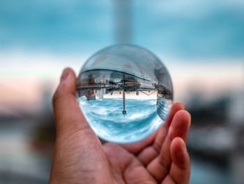 Close-up of hand holding crystal ball
